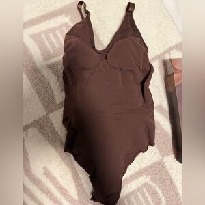 SKIMS Seamless Sculpting Thong Bodysuit in Cocoa